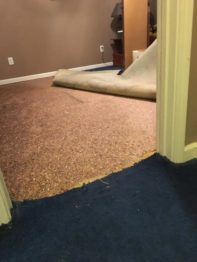 Carpet pad removal revealing water damage during Water Mitigation Services in Mocksville